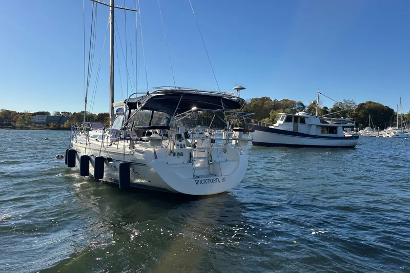 Sandman Yacht Photos Pics 2004 Catalina 400 MkII sailboat anchored in a scenic harbor.