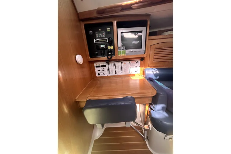 Sandman Yacht Photos Pics Navigation station in 2004 Catalina 400 MkII sailboat with control panel and seating.