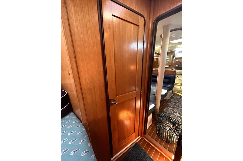Sandman Yacht Photos Pics Interior of 2004 Catalina 400 MkII sailboat with wooden door and cozy seating area.