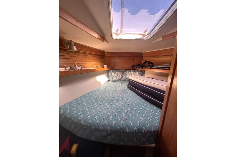 Sandman Yacht Photos Pics Cozy cabin interior of 2004 Catalina 400 MkII sailboat with skylight and patterned bedding.