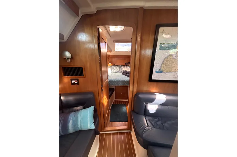 Sandman Yacht Photos Pics Interior of 2004 Catalina 400 MkII sailboat with cozy seating and wooden finishes.