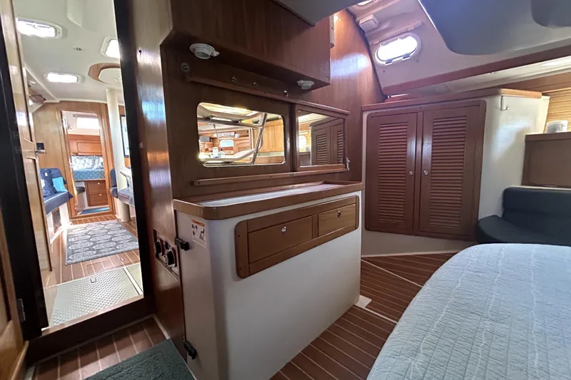 Sandman Yacht Photos Pics Interior of 2004 Catalina 400 MkII sailboat with wood cabinetry and cozy seating area.