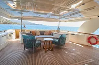 Luxurious Custom Line Navetta 33 yacht deck with seating, ocean view, and elegant decor.