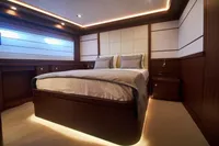 Luxurious bedroom interior on Custom Line Navetta 33 yacht, 2010 model, with elegant wood finishes.