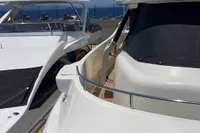 Luxury yachts docked, featuring a 2010 Custom Line Navetta 33 under clear blue skies.