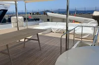 Luxurious deck of 2010 Custom Line Navetta 33 yacht with seating and ocean view.