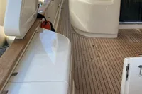 Luxurious Custom Line Navetta 33 yacht deck, 2010 model, with sleek wood finish and modern design.