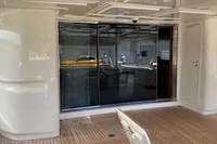 Luxury yacht deck with sliding glass doors, Custom Line Navetta 33, 2010 model.