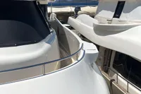 Luxurious Custom Line Navetta 33 yacht docked, 2010 model, with clear blue sky background.
