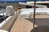 Spacious deck of 2010 Custom Line Navetta 33 yacht with covered seating area.