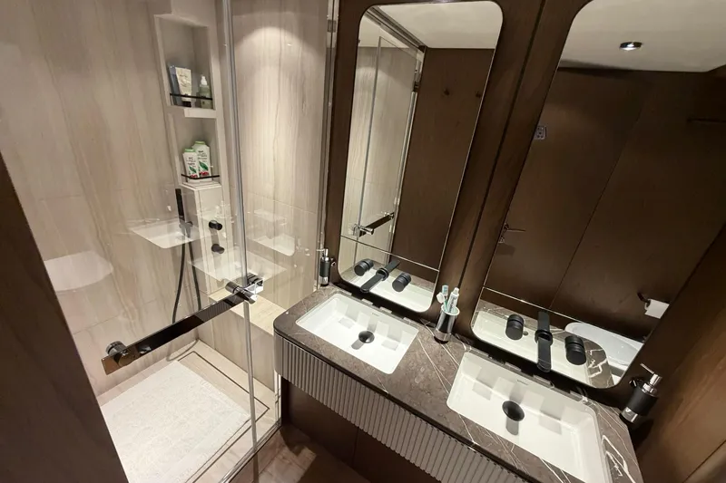  Yacht Photos Pics Luxurious bathroom in 2023 Ferretti Yachts 780, featuring dual sinks and modern shower.