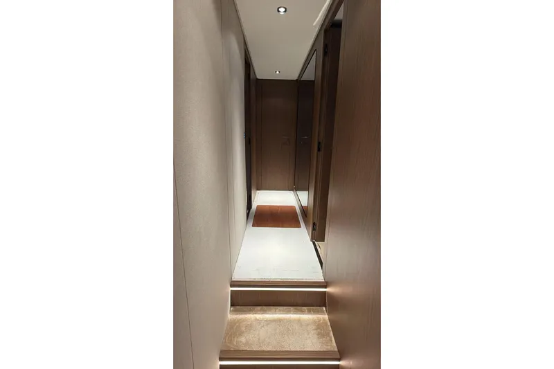  Yacht Photos Pics Luxurious interior hallway of 2023 Ferretti Yachts 780, featuring elegant wood paneling.