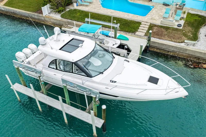  Yacht Photos Pics 2019 Intrepid 410 Evolution yacht docked, featuring sleek design and multiple engines.