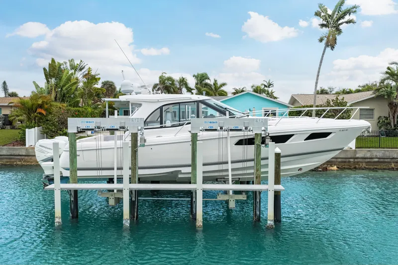  Yacht Photos Pics 2019 Intrepid 410 Evolution yacht on lift, surrounded by tropical scenery.