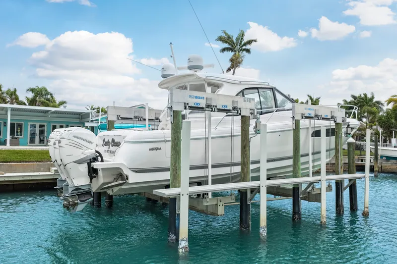  Yacht Photos Pics 2019 Intrepid 410 Evolution boat on lift, docked in tropical marina setting.
