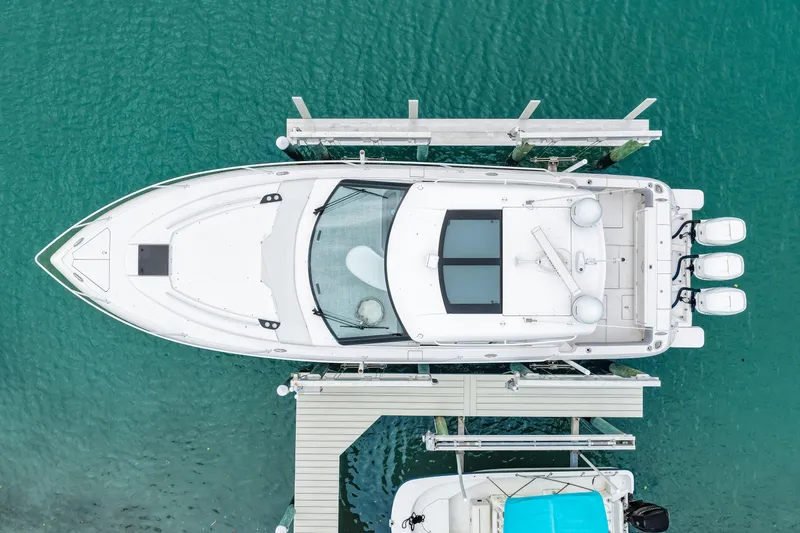  Yacht Photos Pics Aerial view of 2019 Intrepid 410 Evolution yacht docked on turquoise water.