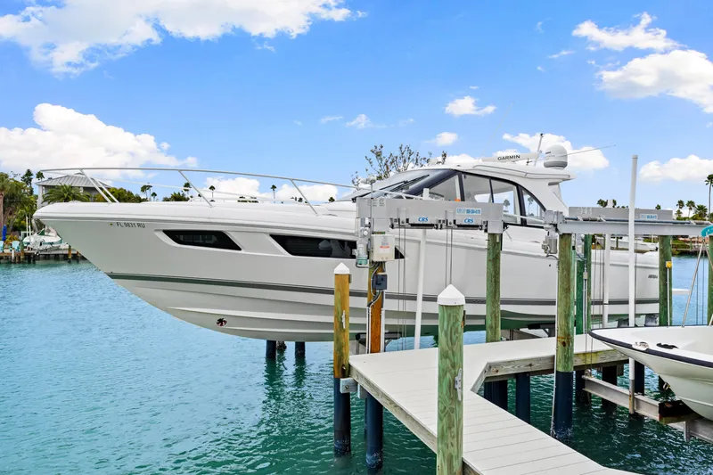  Yacht Photos Pics 2019 Intrepid 410 Evolution yacht docked on a lift in a marina.