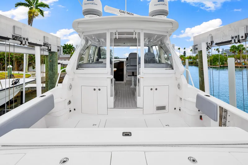  Yacht Photos Pics 2019 Intrepid 410 Evolution yacht docked, showcasing spacious deck and sleek design.