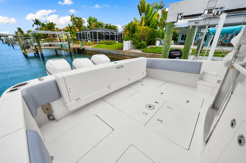  Yacht Photos Pics 2019 Intrepid 410 Evolution boat deck with seating, docked by waterfront homes.
