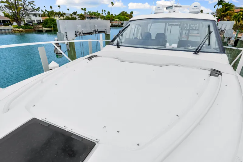  Yacht Photos Pics 2019 Intrepid 410 Evolution yacht docked by serene waterfront.