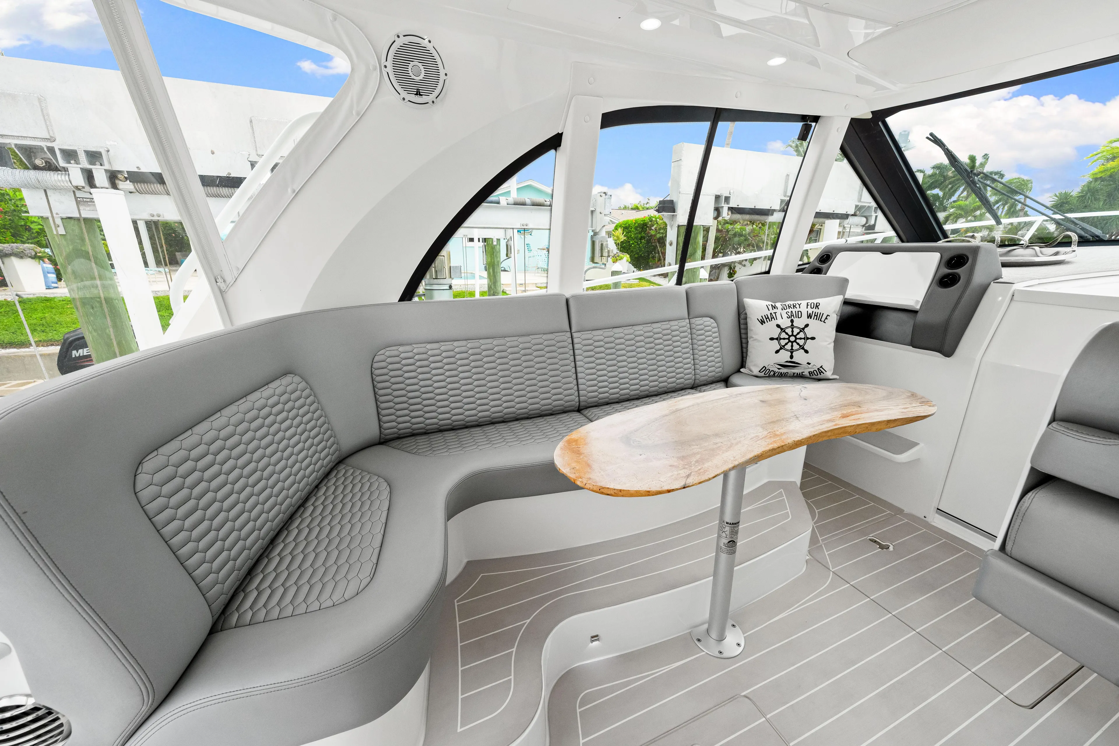  Yacht Photos Pics Luxurious interior of 2019 Intrepid 410 Evolution yacht with elegant seating and wooden table.
