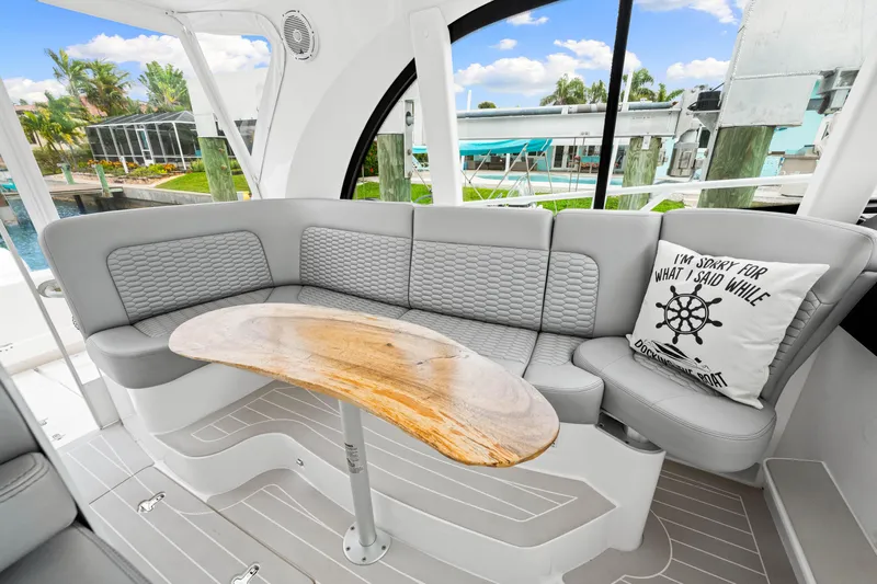  Yacht Photos Pics Luxurious 2019 Intrepid 410 Evolution yacht interior with elegant seating and wooden table.