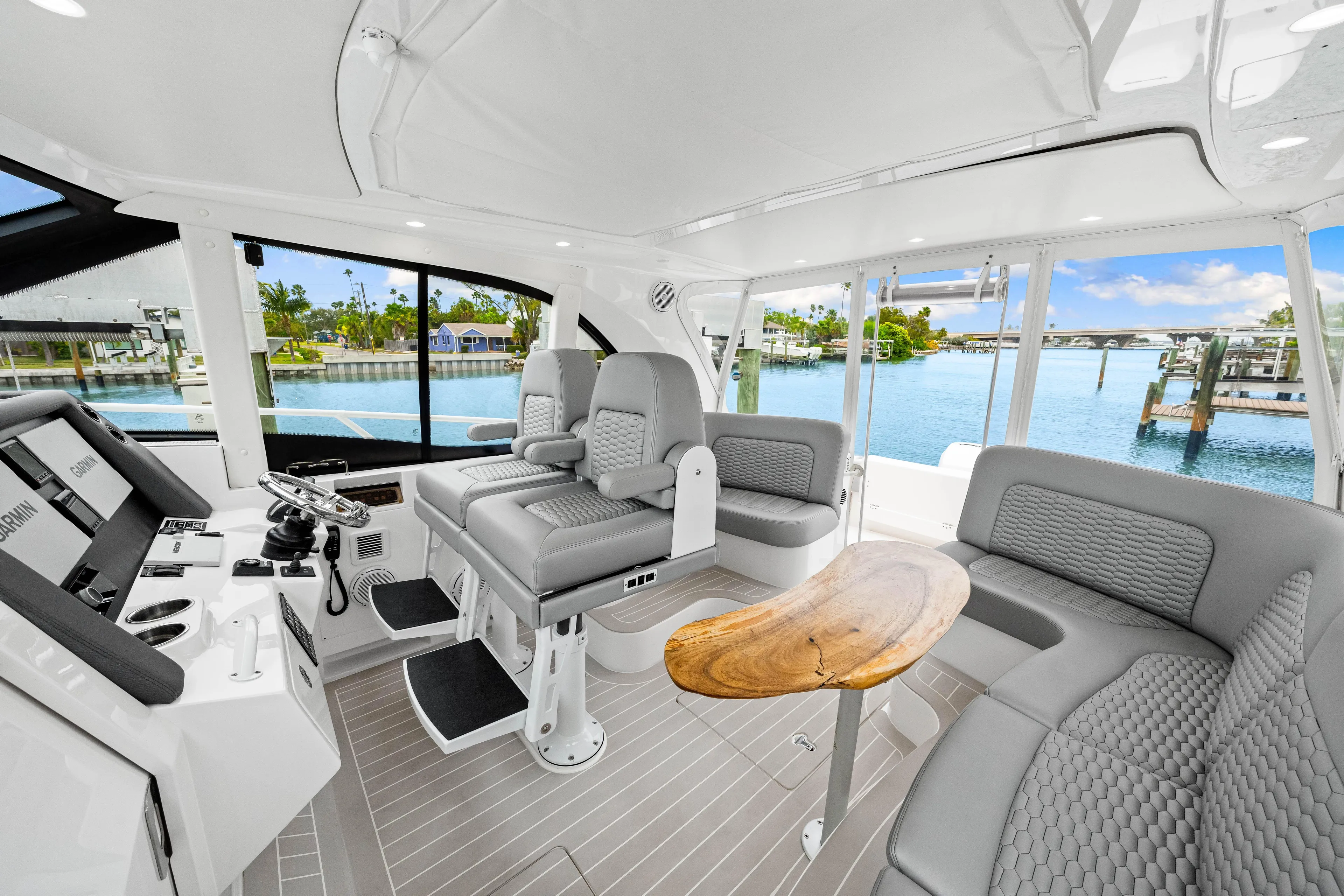  Yacht Photos Pics Luxurious interior of 2019 Intrepid 410 Evolution yacht with modern seating and scenic water view.