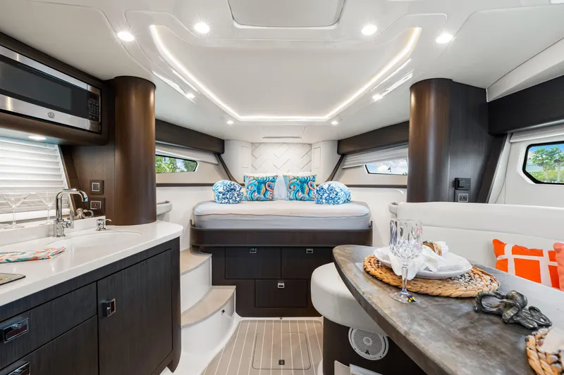  Yacht Photos Pics Luxurious interior of 2019 Intrepid 410 Evolution yacht with modern kitchen and cozy sleeping area.