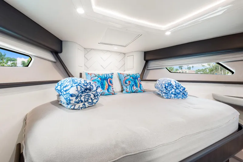  Yacht Photos Pics Luxurious cabin interior of 2019 Intrepid 410 Evolution yacht with elegant bedding.