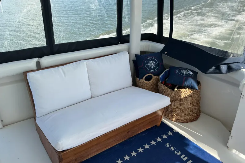 Ananda Yacht Photos Pics Cozy seating area on 1999 Silverton 422 Motor Yacht with ocean view and nautical decor.