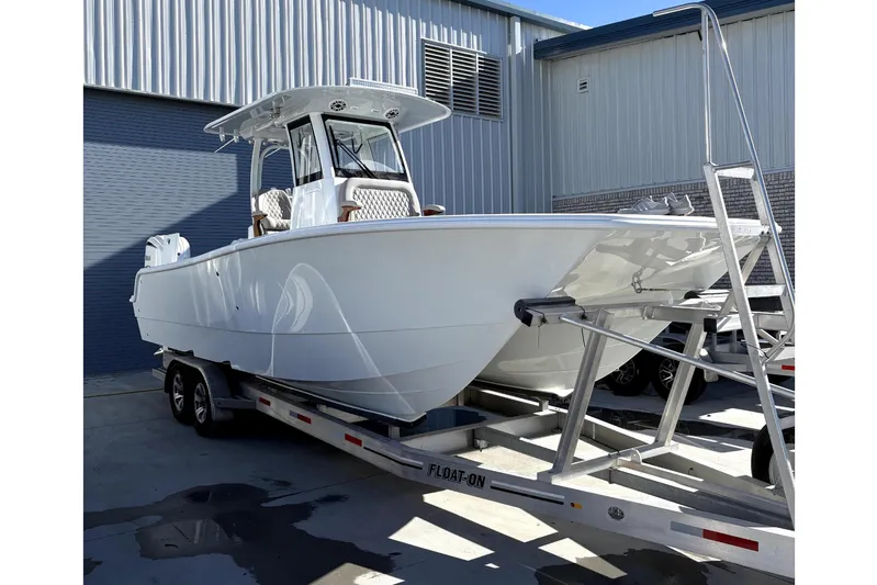 Brand New Yacht Photos Pics 2026 Freeman 28 boat on trailer outside warehouse.