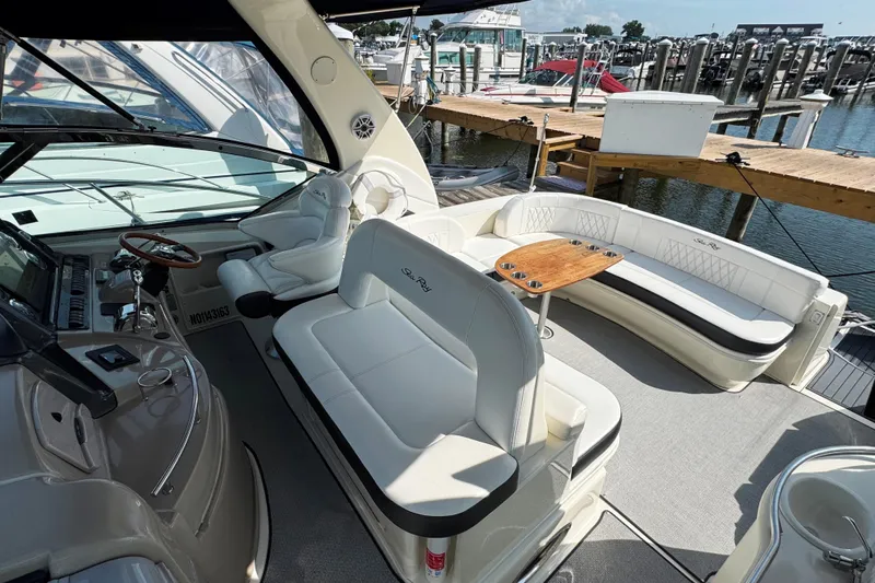  Yacht Photos Pics 2003 Sea Ray 420 Sundancer yacht interior with white seating and wooden table.