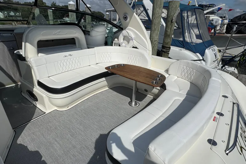  Yacht Photos Pics Luxurious 2003 Sea Ray 420 Sundancer yacht interior with white seating and wooden table.