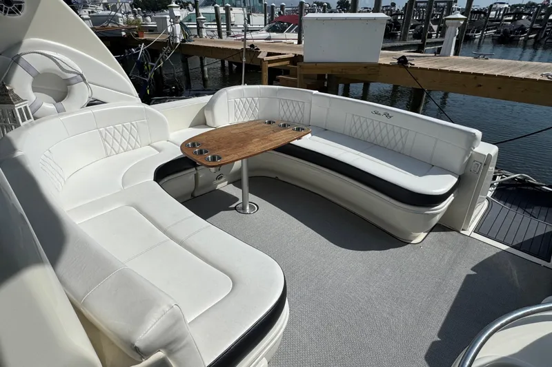  Yacht Photos Pics Luxurious seating area on 2003 Sea Ray 420 Sundancer yacht with wooden table and cup holders.