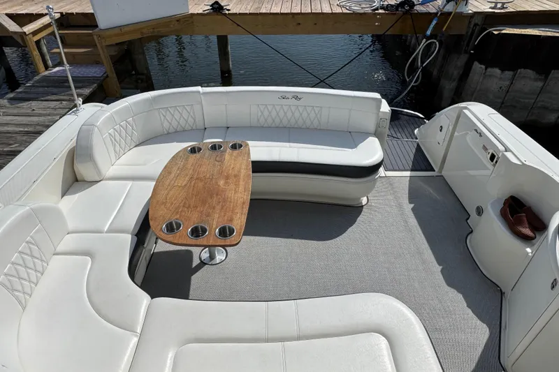  Yacht Photos Pics 2003 Sea Ray 420 Sundancer boat with white seating and wooden table, docked by the water.