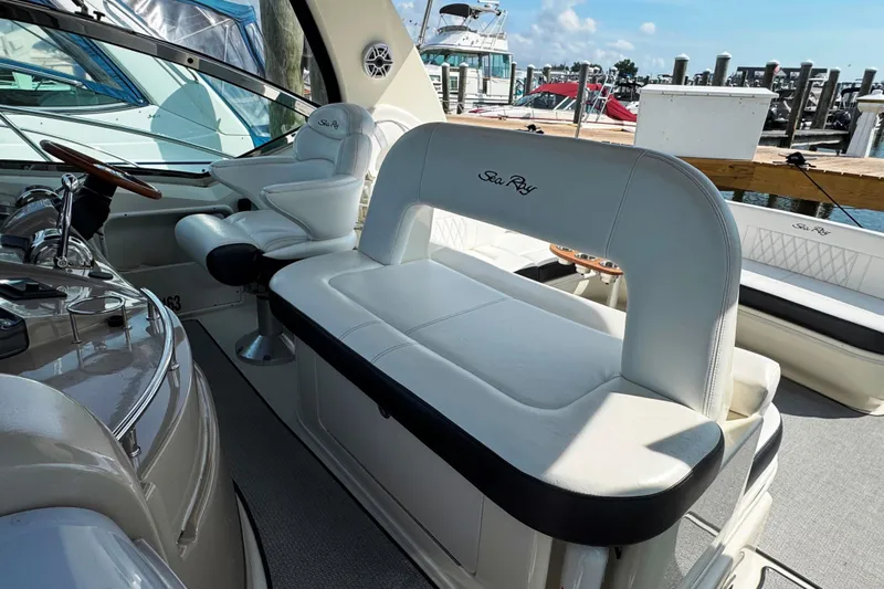  Yacht Photos Pics 2003 Sea Ray 420 Sundancer interior with white seating and helm, docked at marina.