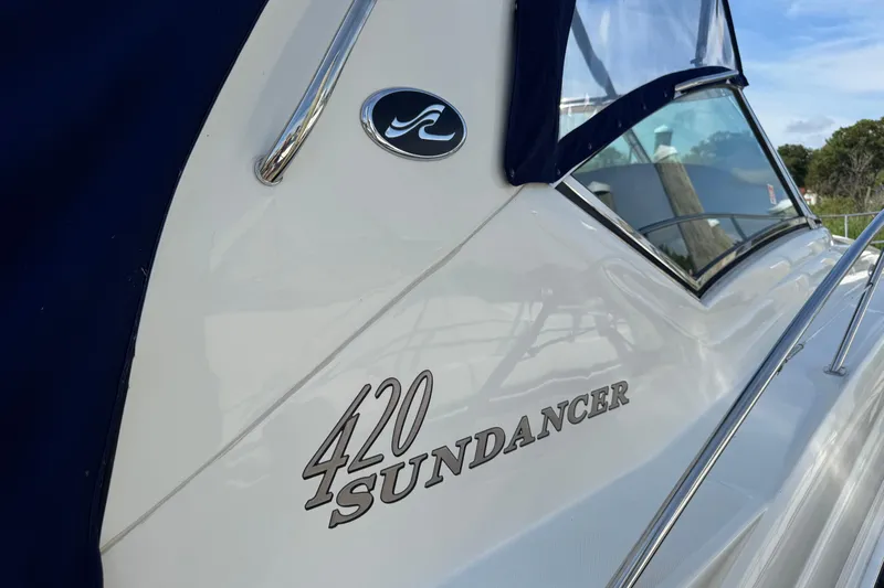  Yacht Photos Pics 2003 Sea Ray 420 Sundancer boat with sleek design and logo detail.