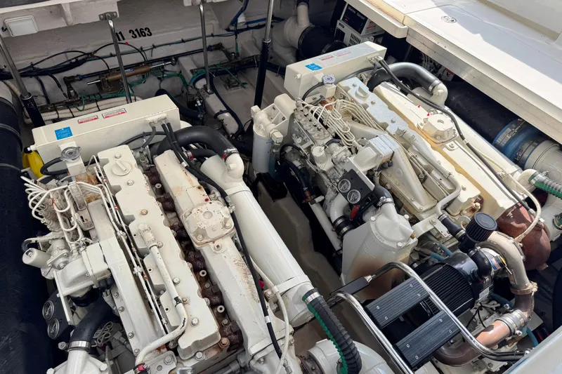 Yacht Photos Pics Engine room of a 2003 Sea Ray 420 Sundancer boat, showcasing dual engines.