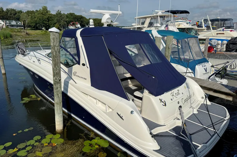  Yacht Photos Pics 2003 Sea Ray 420 Sundancer yacht docked at marina, featuring blue canopy.