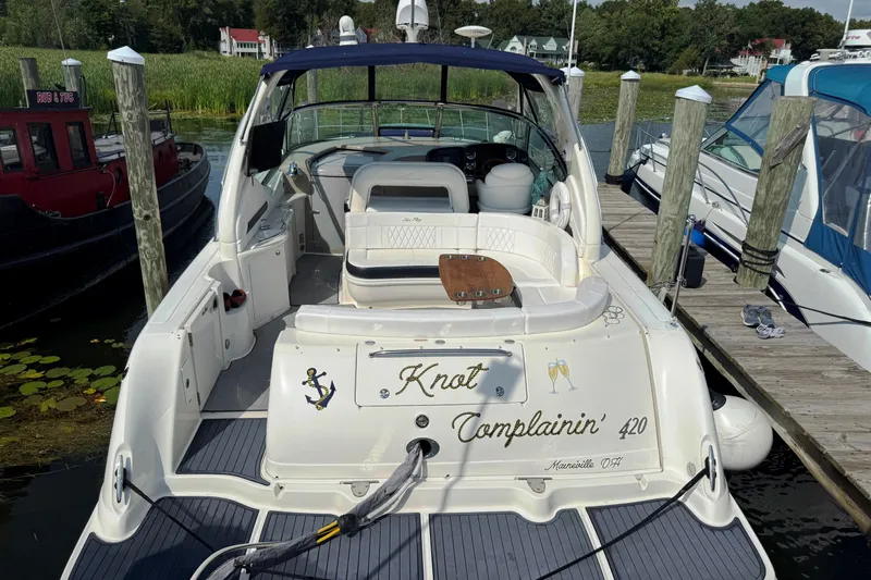  Yacht Photos Pics 2003 Sea Ray 420 Sundancer docked, featuring spacious seating and elegant design.