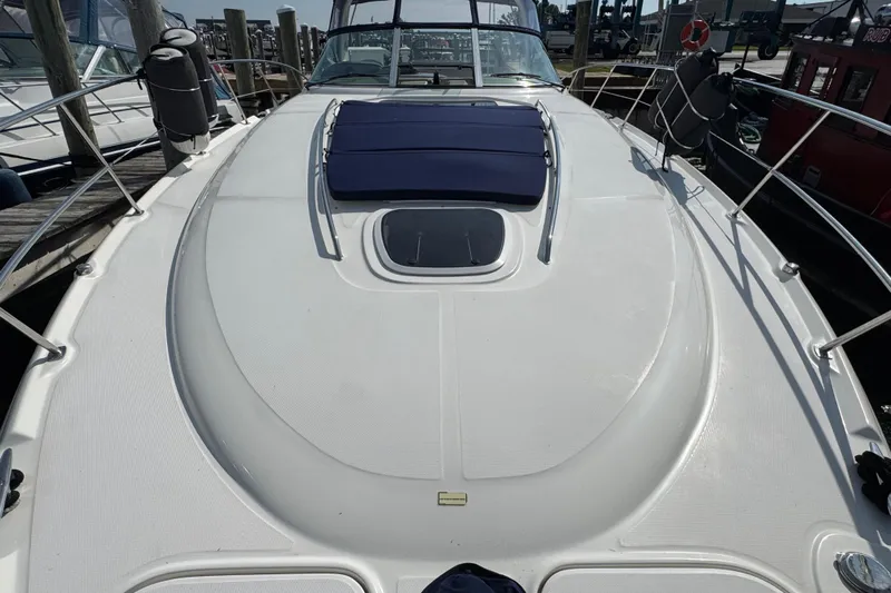  Yacht Photos Pics 2003 Sea Ray 420 Sundancer yacht deck with sunpad and railing in marina.