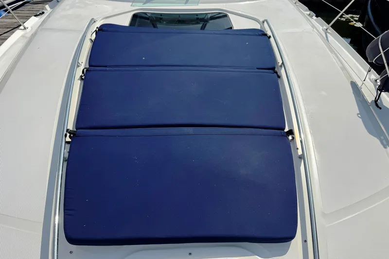  Yacht Photos Pics 2003 Sea Ray 420 Sundancer with blue sun pads on deck.