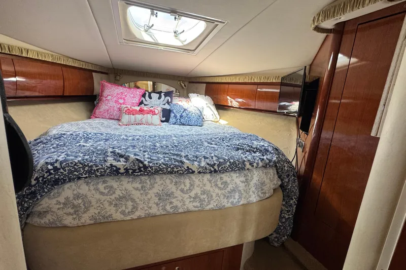 Yacht Photos Pics Luxurious cabin interior of 2003 Sea Ray 420 Sundancer with elegant bedding and wood finishes.