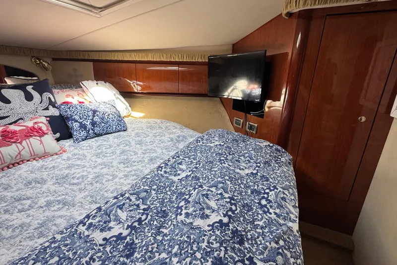  Yacht Photos Pics Luxurious cabin interior of 2003 Sea Ray 420 Sundancer with elegant bedding and TV.