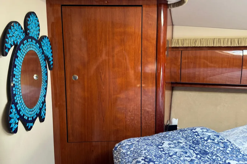  Yacht Photos Pics Interior of 2003 Sea Ray 420 Sundancer with wood paneling and turtle wall art.