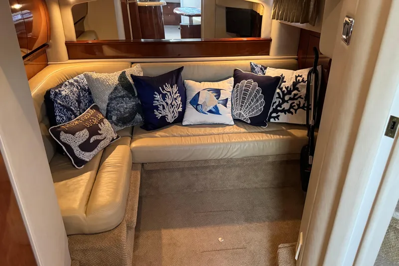  Yacht Photos Pics Interior of 2003 Sea Ray 420 Sundancer with decorative marine-themed pillows on a beige sofa.