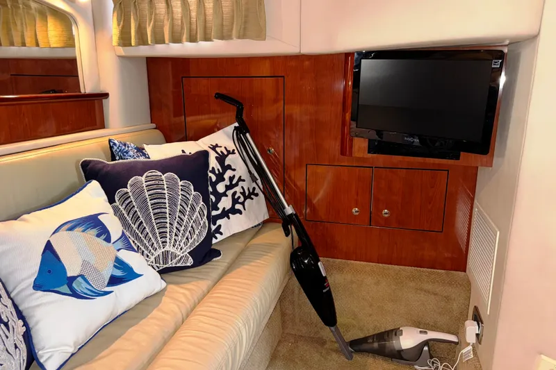  Yacht Photos Pics Interior of 2003 Sea Ray 420 Sundancer with decorative pillows and a vacuum cleaner.