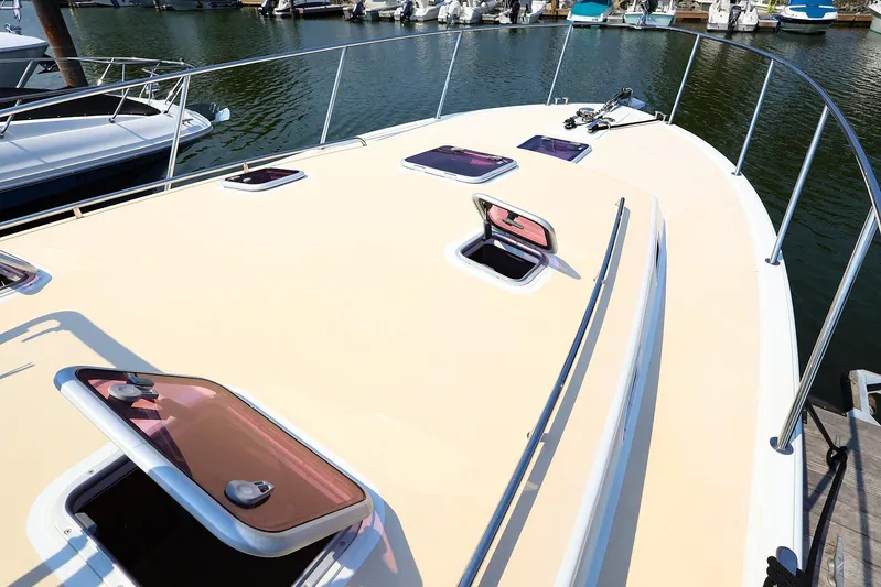 4815tw Yacht Photos Pics 2010 MJM 40z Downeast boat deck with open hatches, docked in marina.