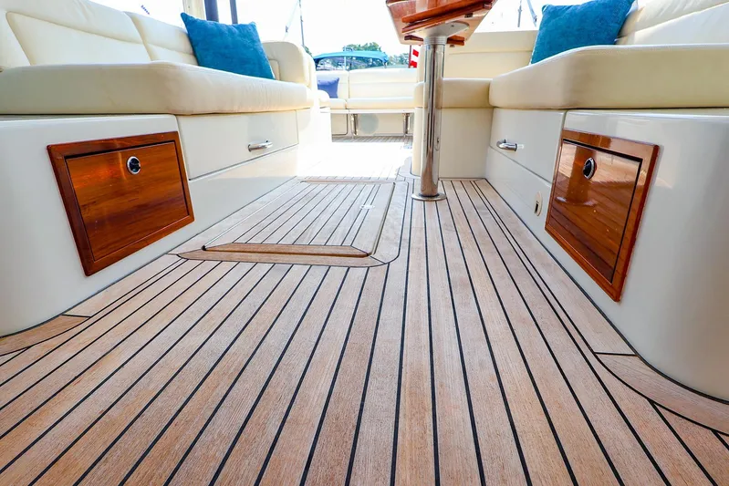 4815tw Yacht Photos Pics Luxurious 2010 MJM 40z Downeast yacht interior with teak flooring and cushioned seating.