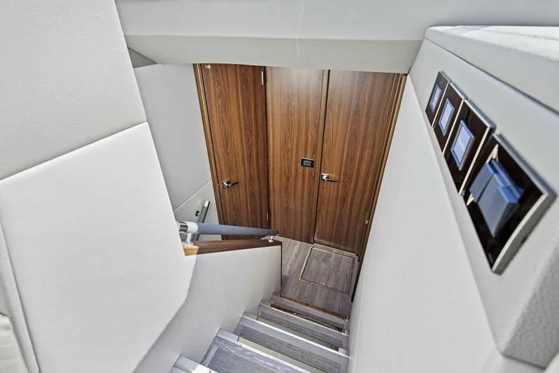 Barbara Sue III Yacht Photos Pics Staircase in 2025 Maritimo M55 yacht with wooden doors and modern design.